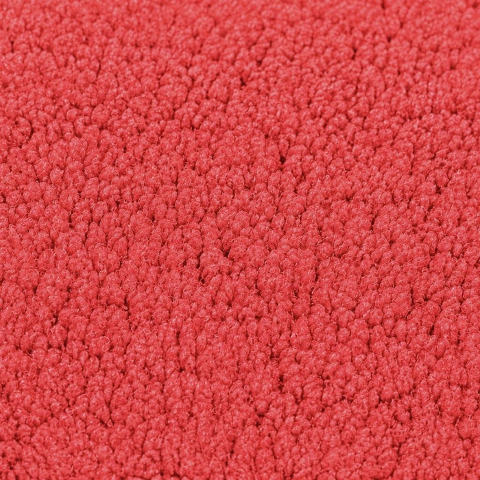 Gros plan de la maille bouclette Orbe Paris, coloris Rouge corail.