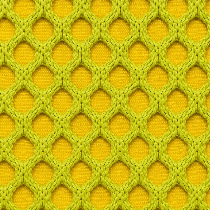 Gros plan du tissu technique Orbe Paris, teinte Jaune anis — relief alvéolé visible.