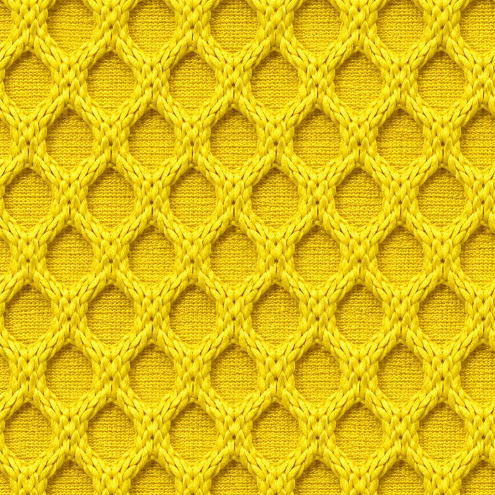 Gros plan du tissu technique Orbe Paris, teinte Jaune vif chaud — relief alvéolé visible.